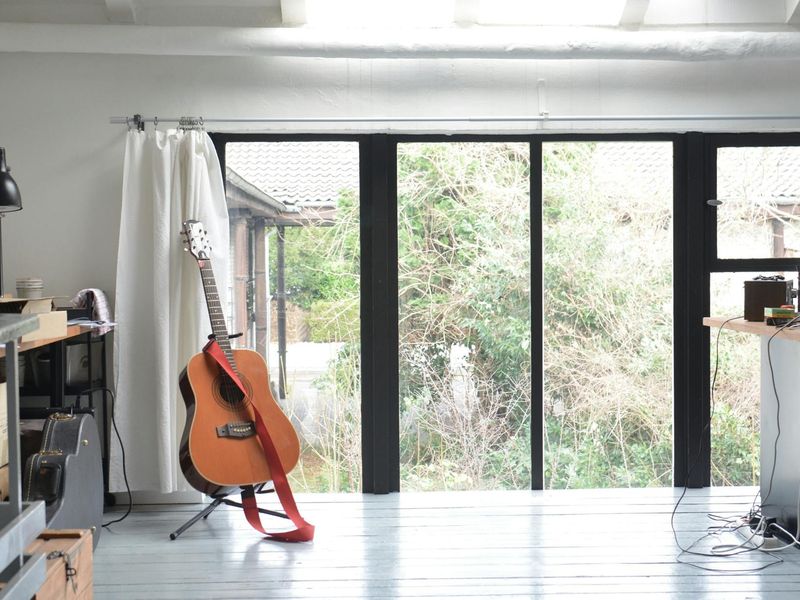 Bright and spacious workout studio with large windows.