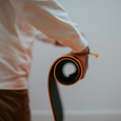 Rolled up blue yoga mat in corner.